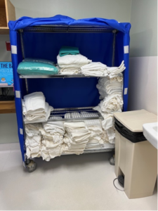 Clean storage adjacent to dirty items in a hospital lobby.