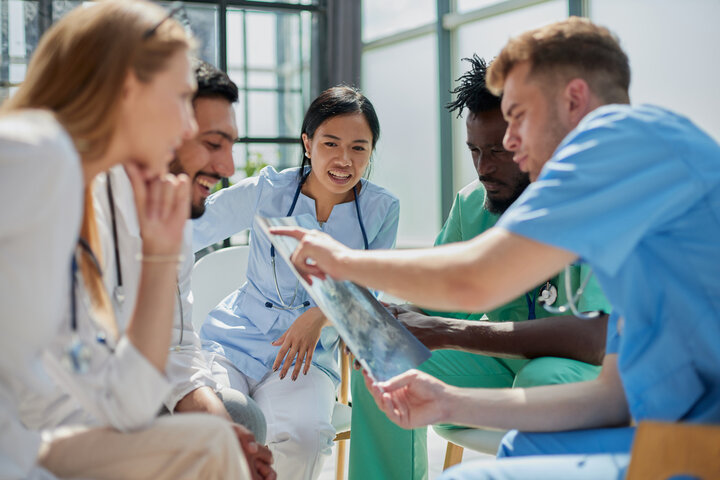 Group of nurses and doctors conferring in a hospital