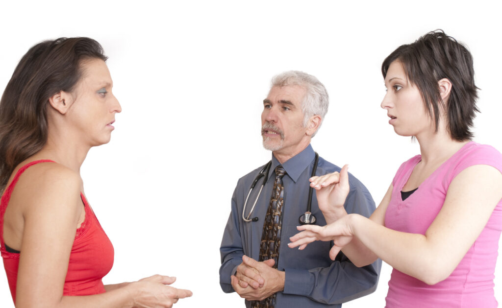 interpreter signing with deaf patient.