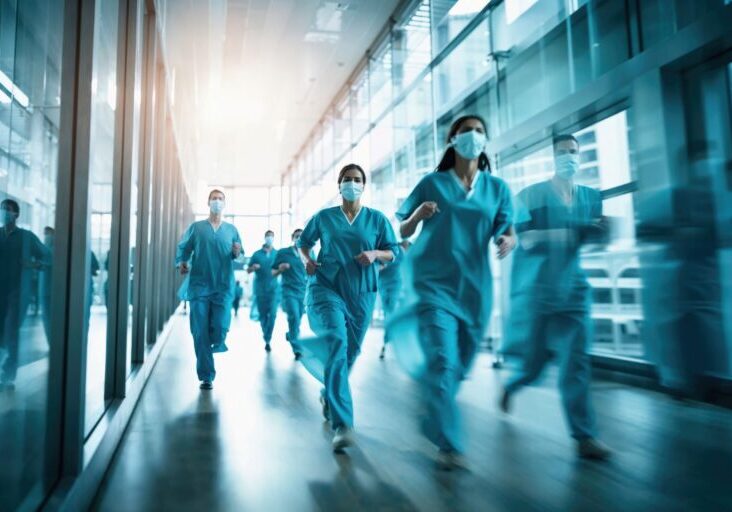 Medical staff in a hurry at a modern hospital corridor.