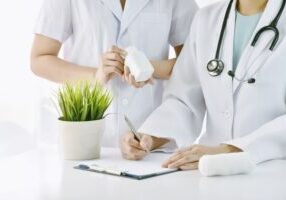 Doctor and nurse or pharmacist discussing about patient drug, Physician writing medication diagnosis note,
