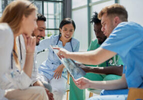 Group of nurses and doctors conferring in a hospital