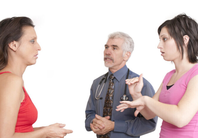 interpreter signing with deaf patient.